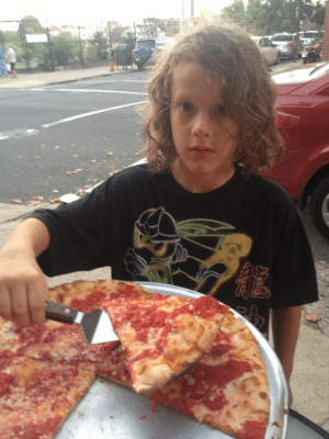 Jacob outside with pizza at Slice Pizza on 10th Street